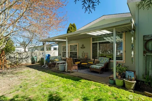 a view of a house with backyard sitting area and porch