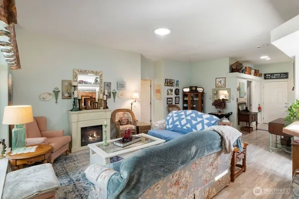 a bedroom with a bed a couch and potted plant on the dresser
