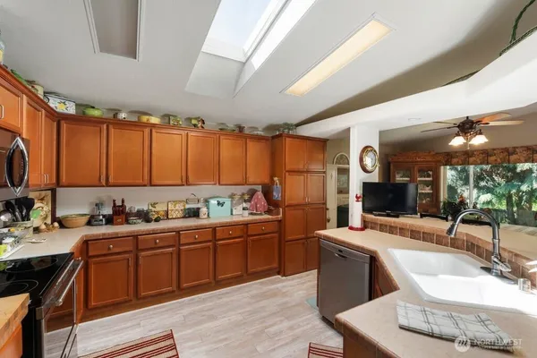 a kitchen with a sink appliances and cabinets