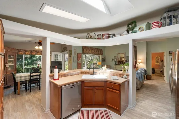 a open kitchen with a sink stove and wooden floor