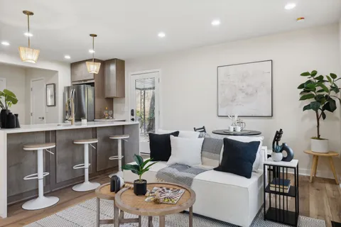 a living room with furniture a chandelier and a table