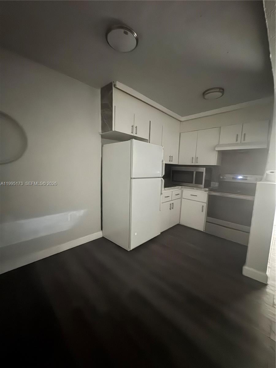 7802 Northwest 8th Avenue, Unit 4 Miami, FL 33150 - Photo 2 of 4 a kitchen with a refrigerator and a stove top oven