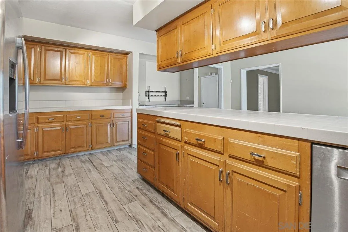 1262 Brittany Cross Road North Tustin, CA 92705 - Photo 27 of 35 a kitchen with stainless steel appliances granite countertop wooden cabinets and a sink