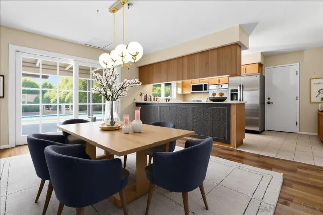 a view of a dining room with furniture a chandelier and wooden floor