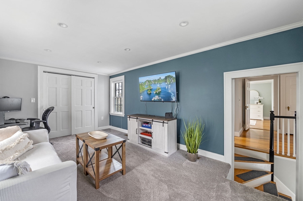 30 Rose Avenue Marblehead, MA 01945 - Photo 24 of 42 a living room with furniture a flat screen tv and a refrigerator