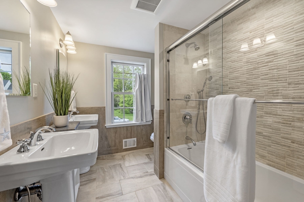 30 Rose Avenue Marblehead, MA 01945 - Photo 33 of 42 a bathroom with a tub sink and mirror