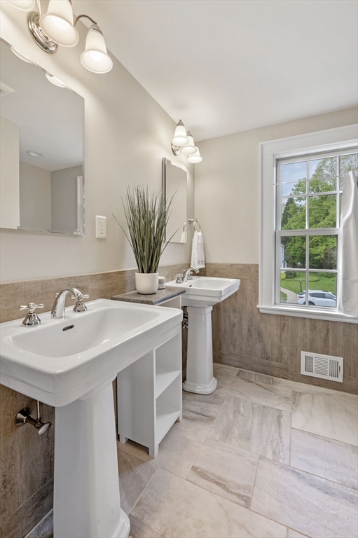30 Rose Avenue Marblehead, MA 01945 - Photo 35 of 42 a bathroom with a sink a mirror and a window