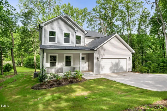 a front view of a house with a yard and porch