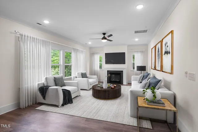 a view of kitchen with kitchen island wooden floors and stainless steel appliances