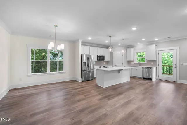 a living room with kitchen island furniture and a kitchen view