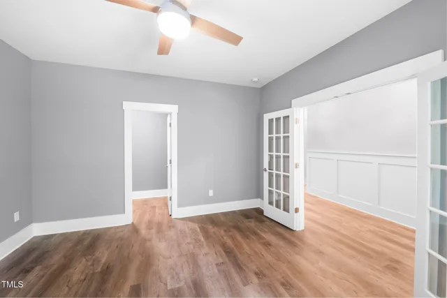 a living room with furniture a rug and a book shelf