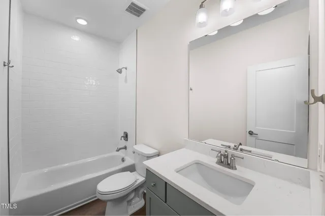 a bathroom with a double vanity sink mirror and shower