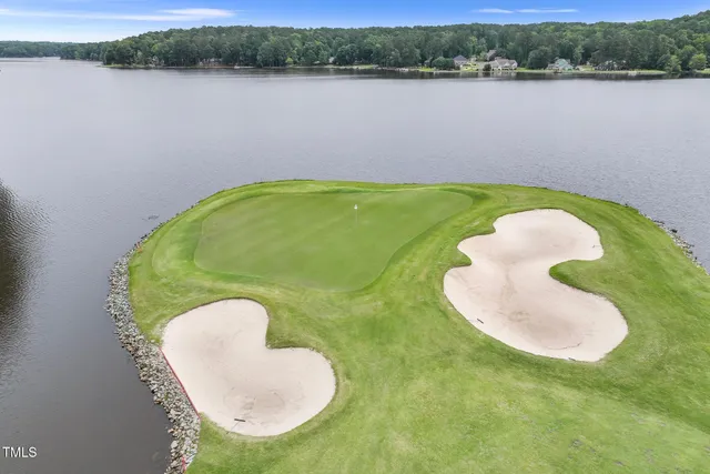 an aerial view of lake residential house with outdoor space and trees around