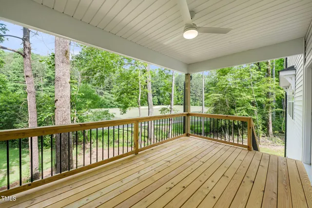 an aerial view of a house with a yard and lake view