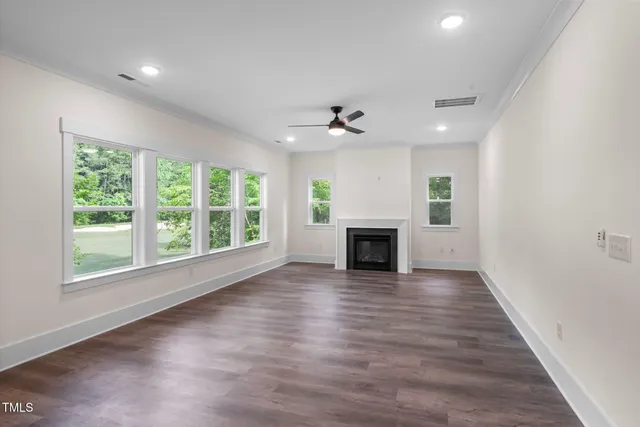 a living room with furniture fireplace and a large window