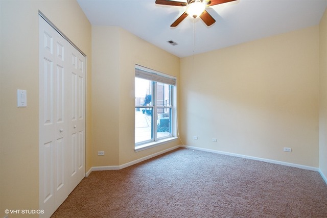 1450 South Halsted Street, Unit 1A Chicago, IL 60607 - Photo 8 of 11 a view of an empty room with a window