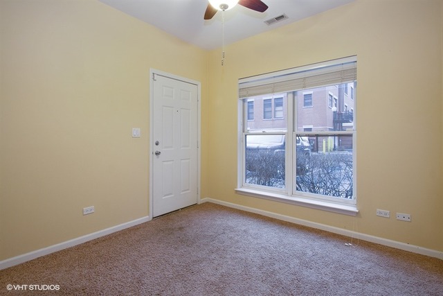 1450 South Halsted Street, Unit 1A Chicago, IL 60607 - Photo 10 of 11 an empty room with a window