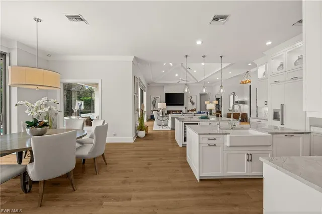 a large kitchen with cabinets wooden floor and stainless steel appliances