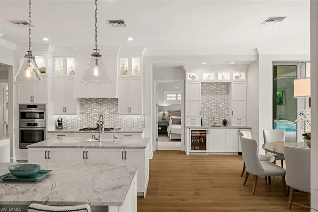 a large kitchen with kitchen island a large counter space and stainless steel appliances