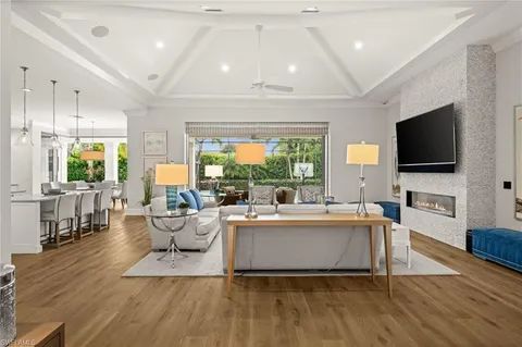a living room with fireplace furniture and a flat screen tv