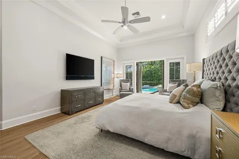 a large white bathroom with a double vanity sink large mirror and a bathtub