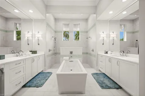 a large bathroom with a double vanity sink large mirror and shower