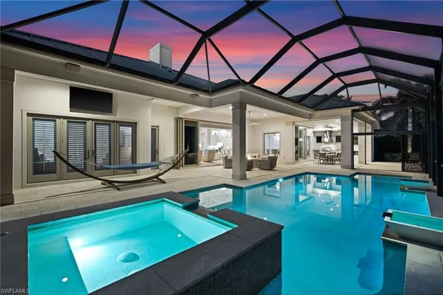 a view of a swimming pool with outdoor seating