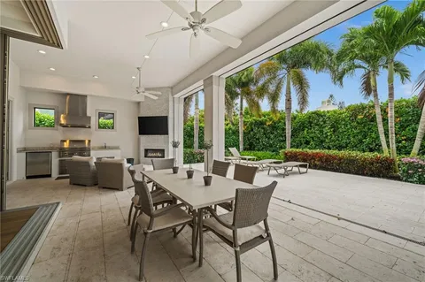 a view of an house with backyard and sitting area