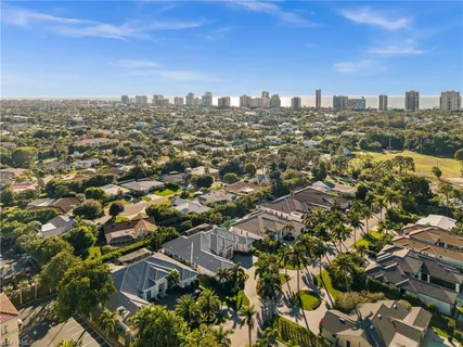 a front view of a house with a yard and potted plants
