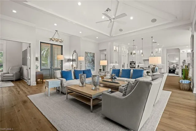 a living room with furniture and a chandelier