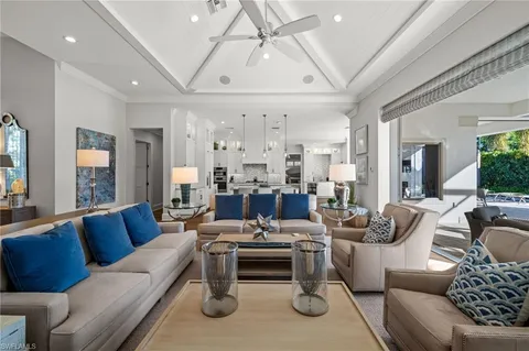 a living room with furniture ceiling fan and a rug
