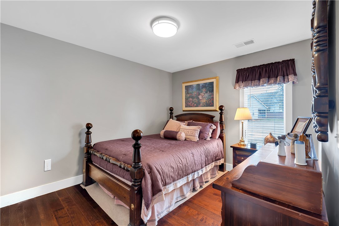 181 Amberwood Drive Anderson, SC 29621 - Photo 21 of 28 This cozy bedroom features rich hardwood flooring and ample natural light, creating a comfortable living space.