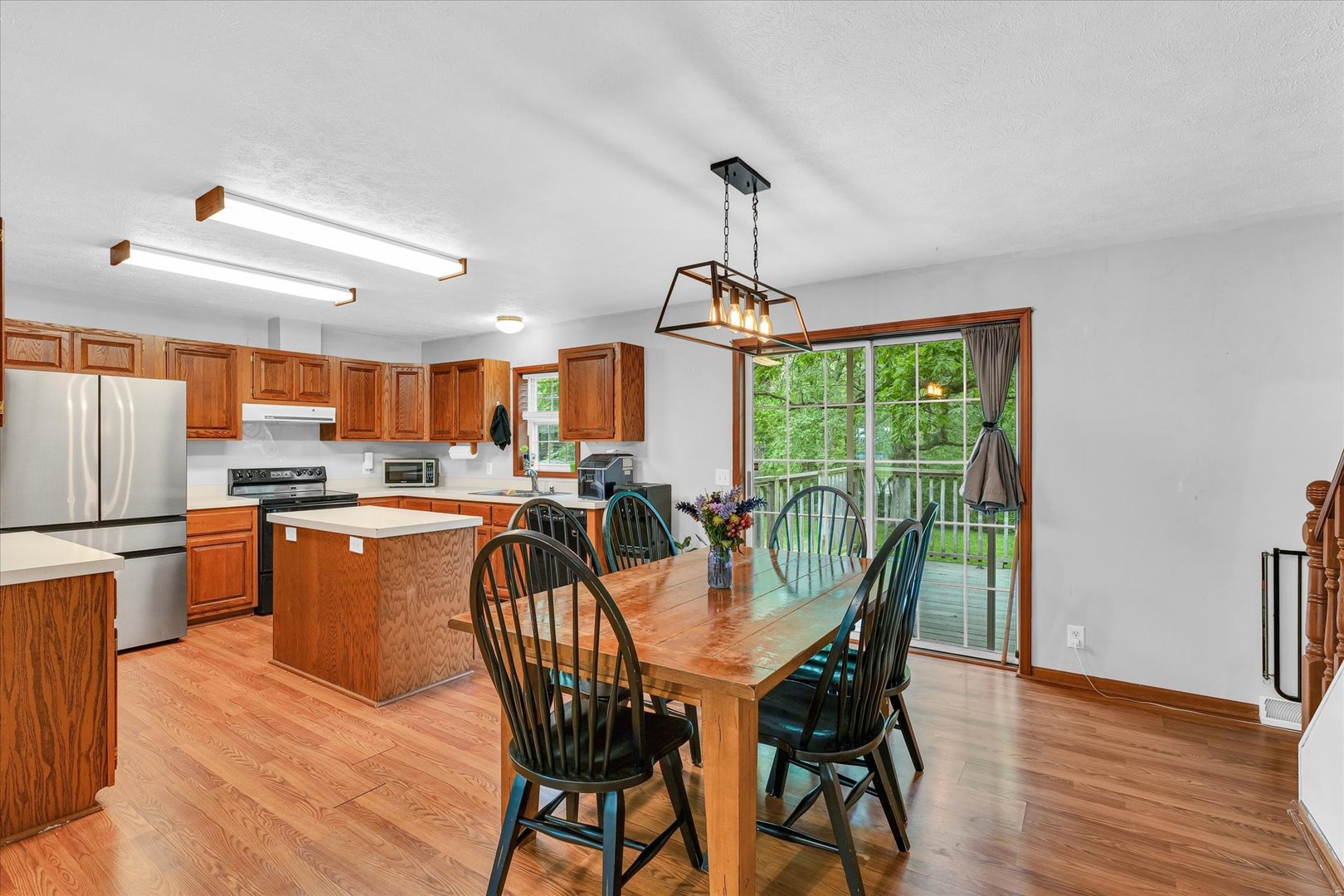 7795 Buttercup Road Weldon, IL 61882 - Photo 11 of 47 a dining room with furniture a chandelier and wooden floor