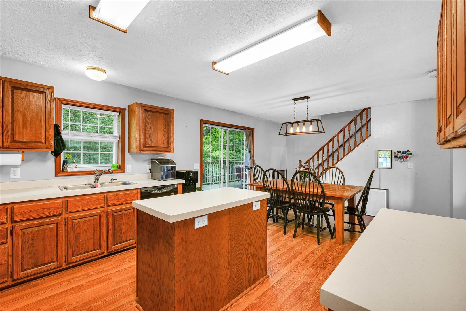 7795 Buttercup Road Weldon, IL 61882 - Photo 15 of 47 a kitchen with stainless steel appliances granite countertop a table chairs sink and wooden floor