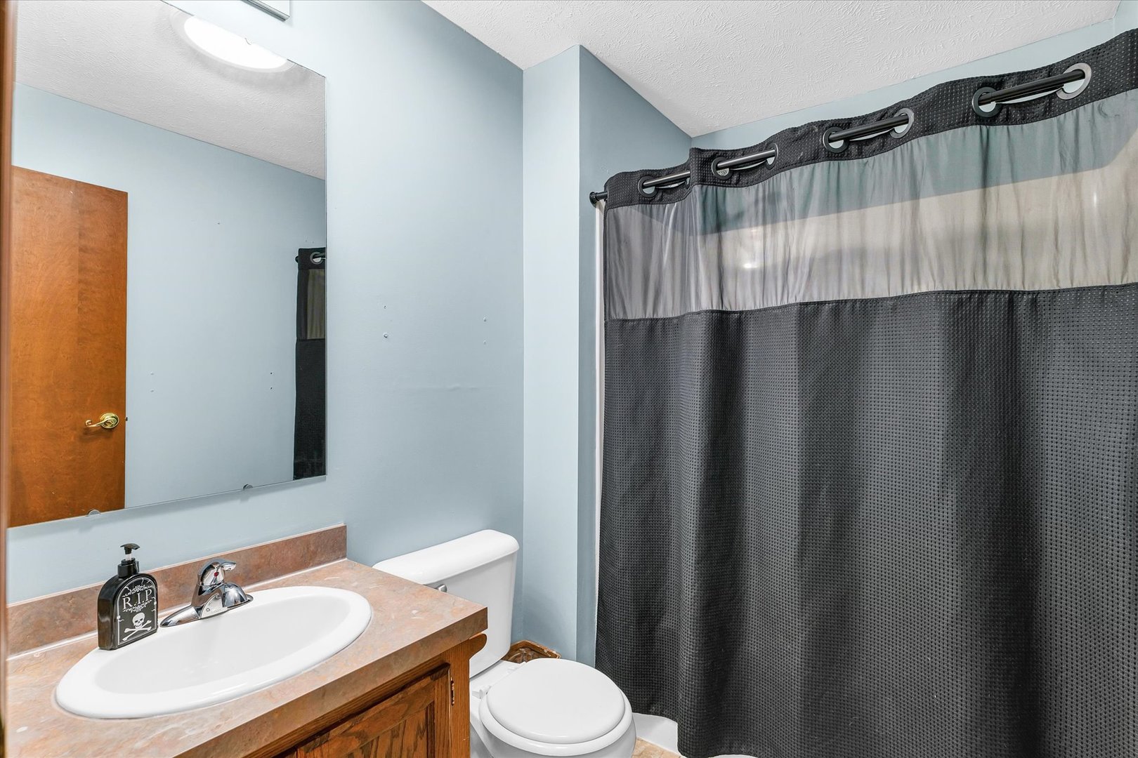 7795 Buttercup Road Weldon, IL 61882 - Photo 17 of 47 a bathroom with a sink and a mirror