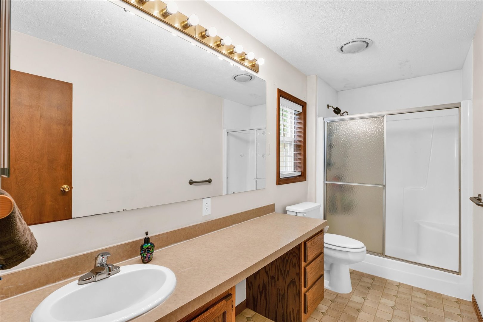 7795 Buttercup Road Weldon, IL 61882 - Photo 20 of 47 a bathroom with a sink toilet and shower