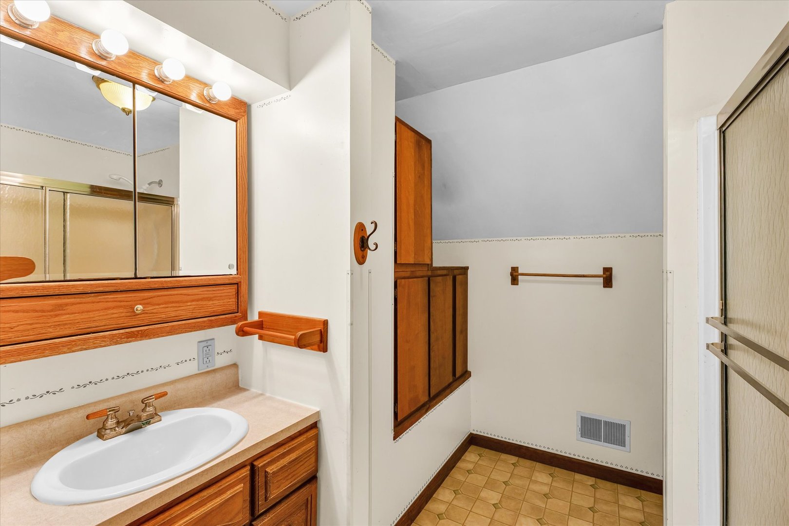 7795 Buttercup Road Weldon, IL 61882 - Photo 30 of 47 a bathroom with a sink and a mirror