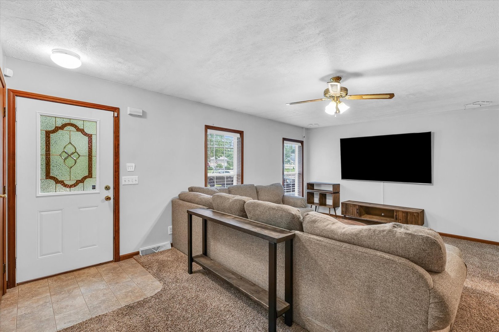7795 Buttercup Road Weldon, IL 61882 - Photo 8 of 47 a living room with furniture and a flat screen tv
