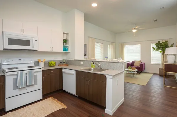 a kitchen with a sink stove and cabinets