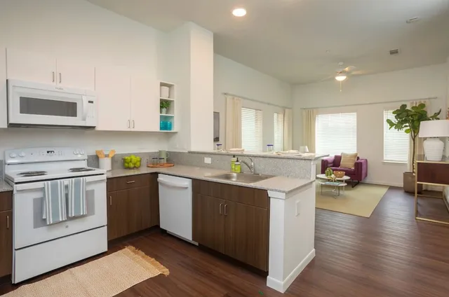 a kitchen with a sink stove and cabinets