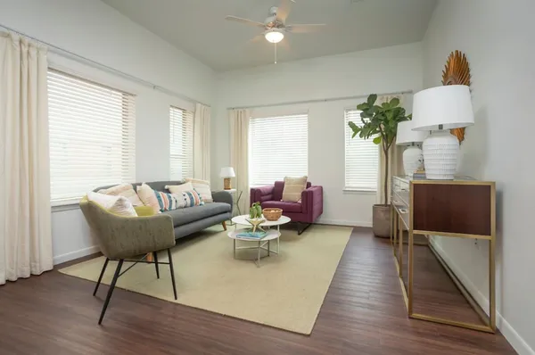 a living room with furniture and wooden floor