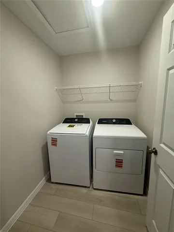 a spacious bathroom with a double vanity sink a mirror and a toilet