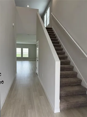 a view of entryway and hall with wooden floor