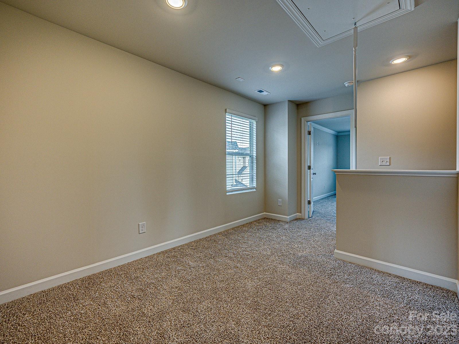 664 Citriadora Street Fort Mill, SC 29715 - Photo 15 of 27 an empty room with windows and refrigerator