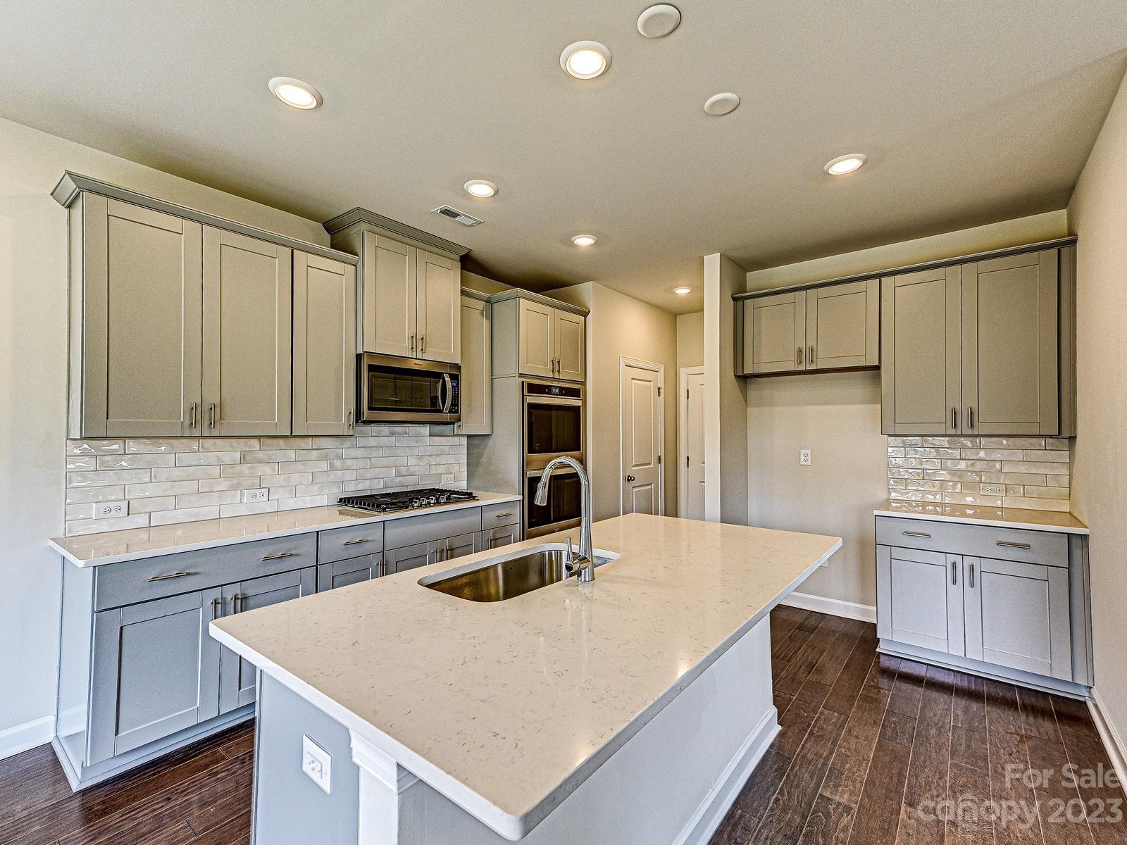 664 Citriadora Street Fort Mill, SC 29715 - Photo 5 of 27 a kitchen with stainless steel appliances granite countertop a sink stove and refrigerator