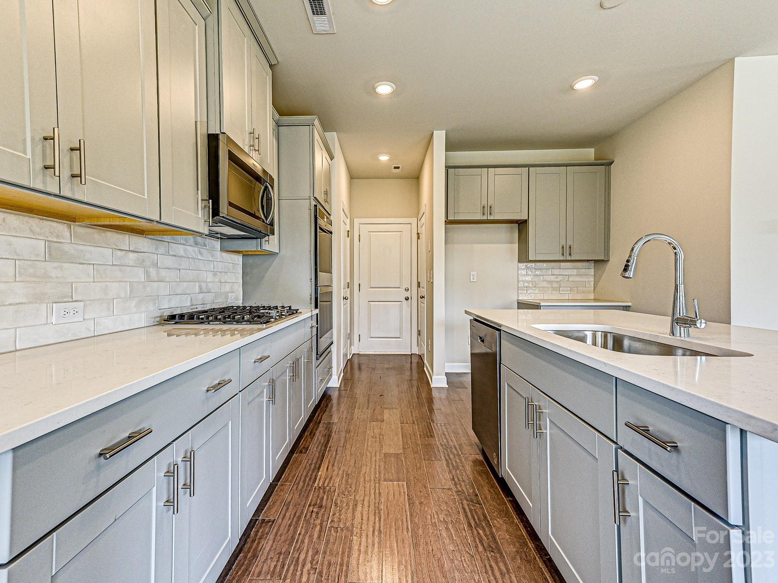 664 Citriadora Street Fort Mill, SC 29715 - Photo 6 of 27 a kitchen with stainless steel appliances granite countertop a sink and cabinets