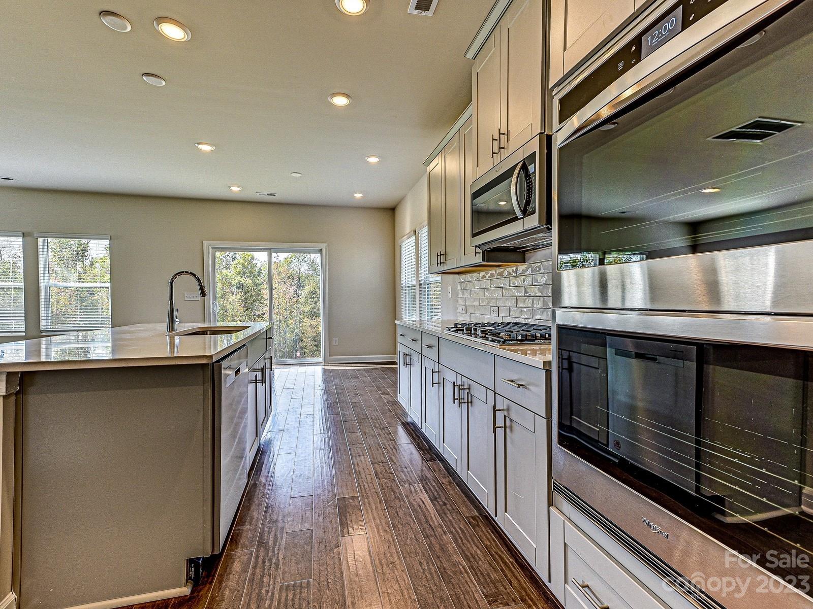 664 Citriadora Street Fort Mill, SC 29715 - Photo 7 of 27 a kitchen with stainless steel appliances granite countertop a stove and a sink