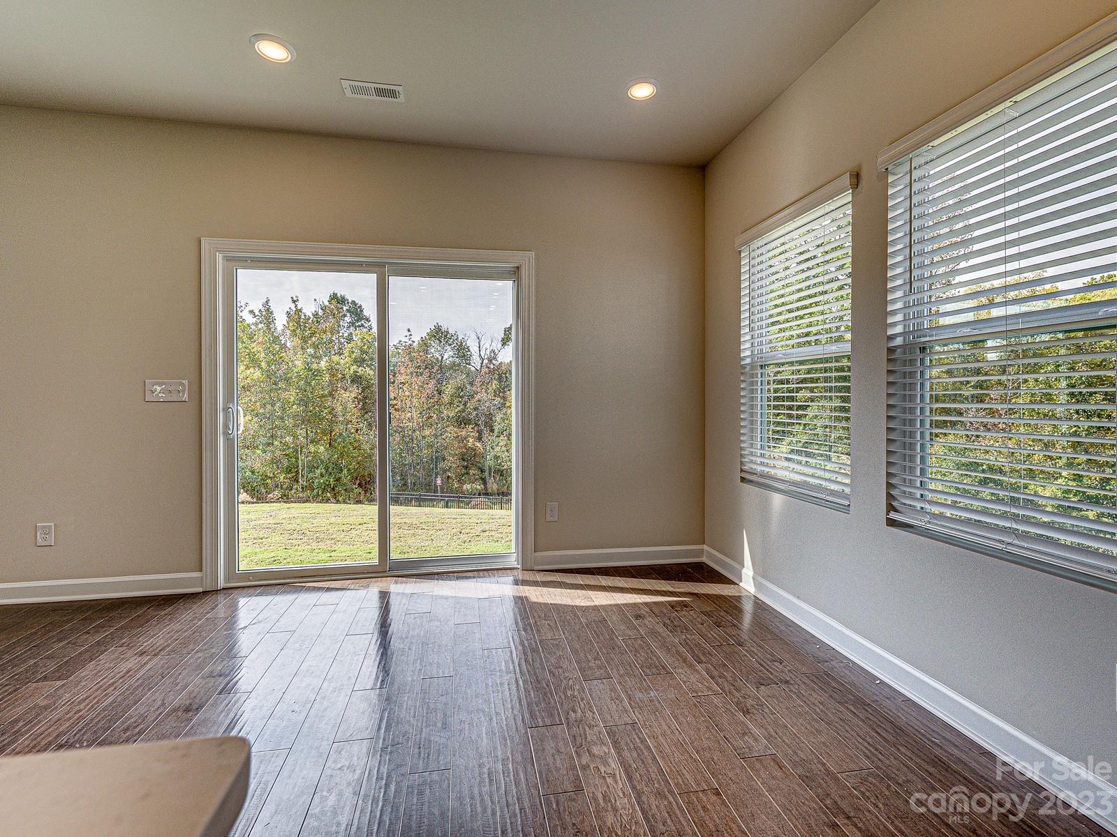 664 Citriadora Street Fort Mill, SC 29715 - Photo 9 of 27 a view of an empty room with wooden floor and a window