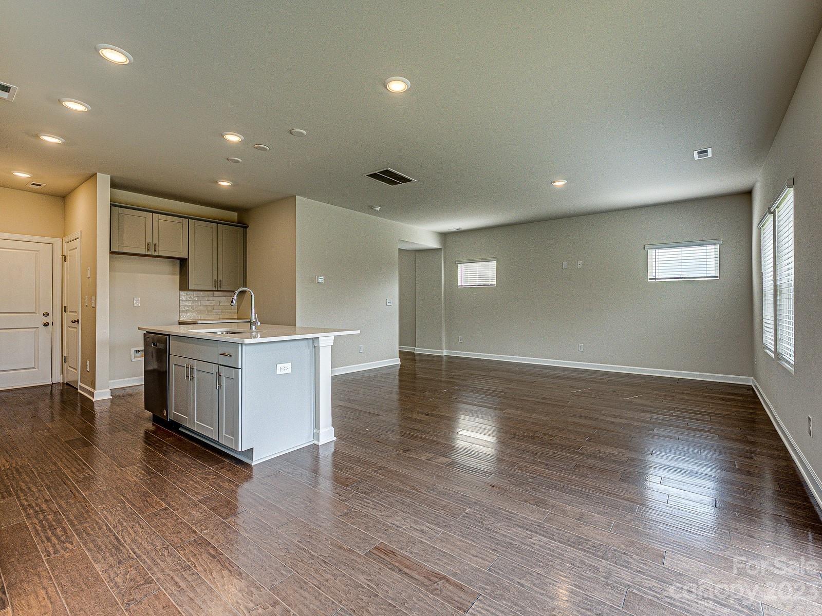 664 Citriadora Street Fort Mill, SC 29715 - Photo 10 of 27 an open kitchen with white cabinets and wooden floor