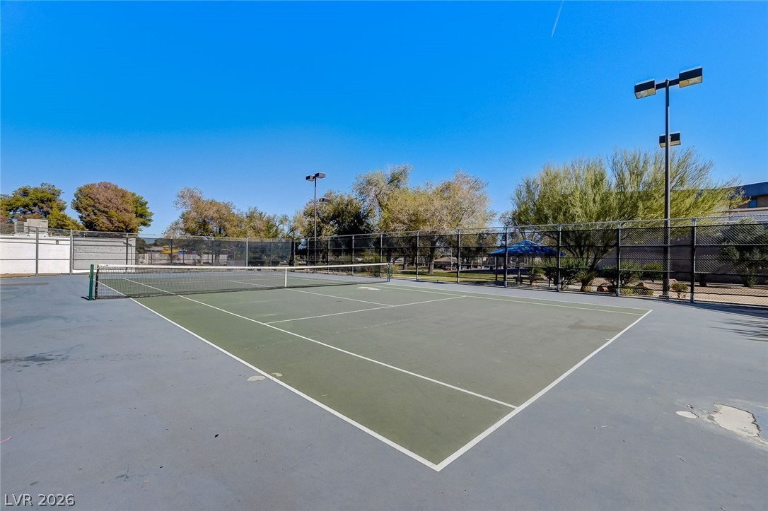 4840 Summerhill Road Las Vegas, NV 89121 - Photo 49 of 56 Serve up some fun on this private, well-maintained tennis court, complete with perimeter fencing and shaded seating.